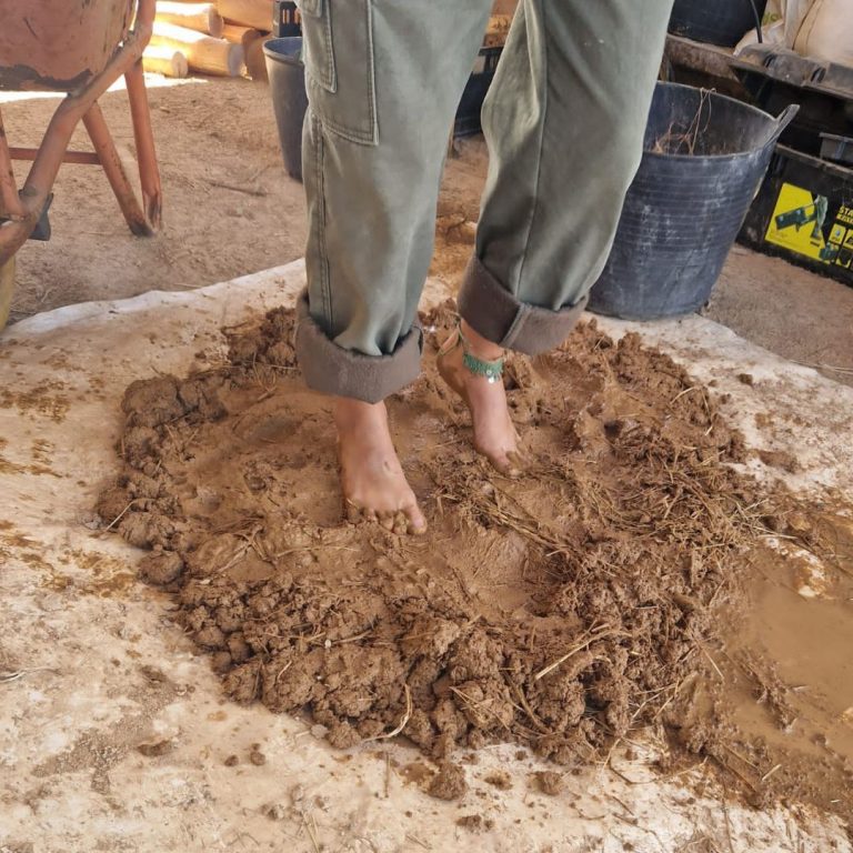 Natural Building - Mixing clay with feet